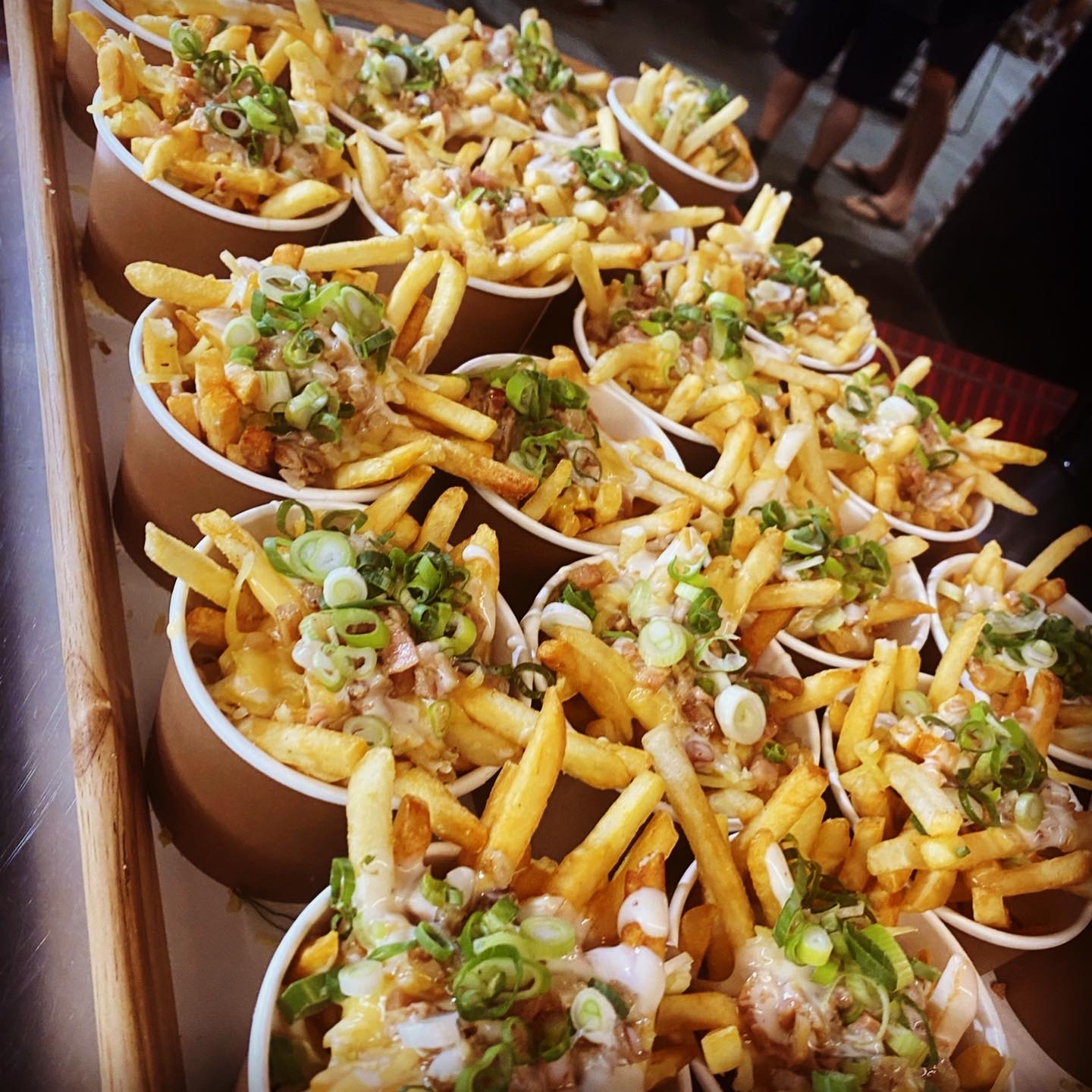 Cups of loaded fries plated for a private catering event on the Gold Coast