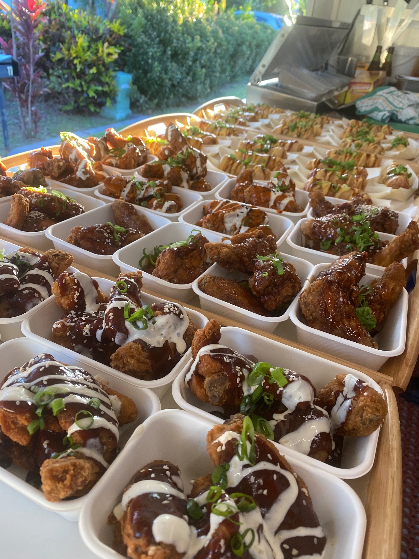 Platters of sauced chicken wings prepared for a corporate catering booking