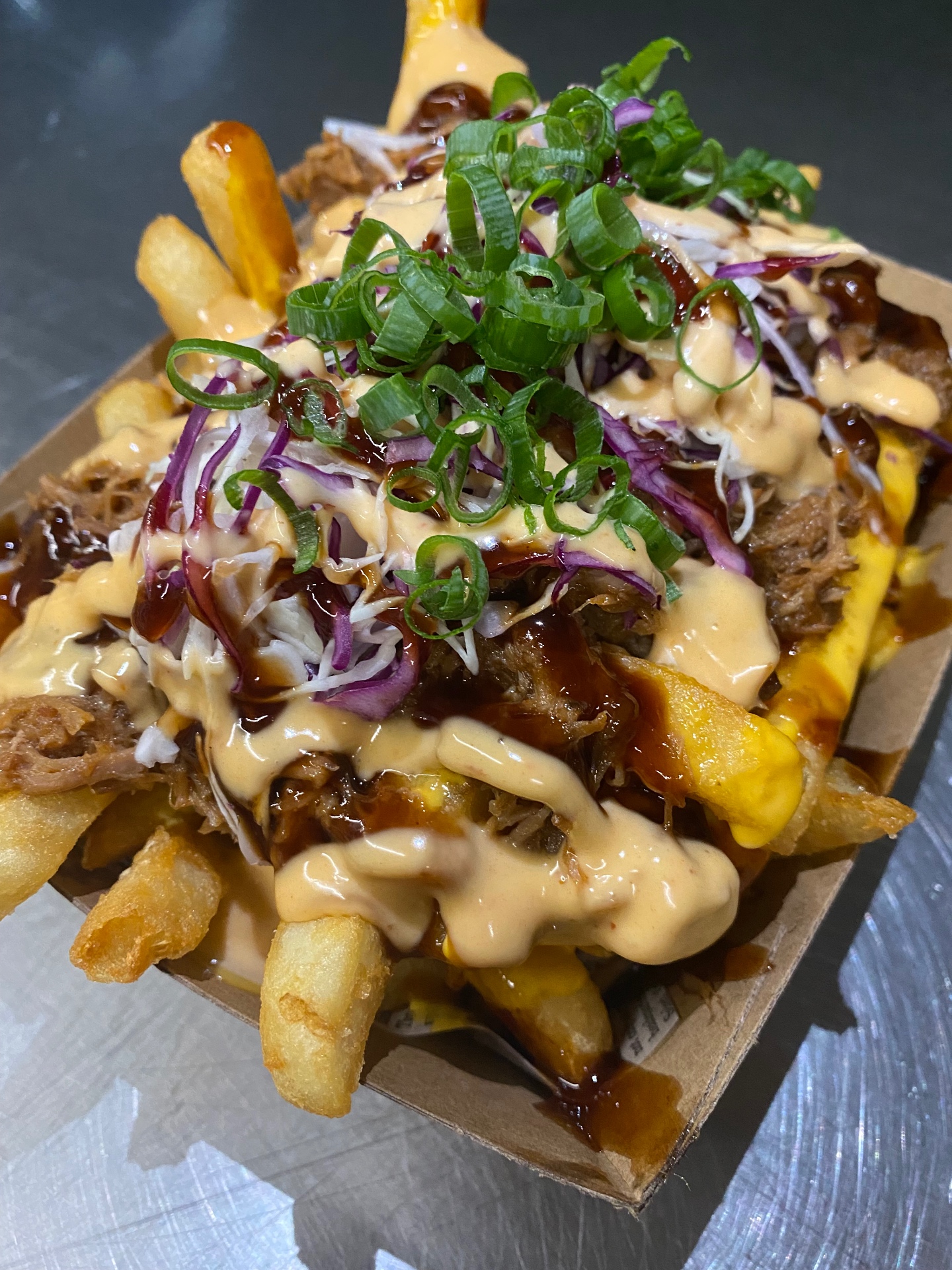 Loaded fries topped with house smoked pulled pork, slaw and chipotle mayo