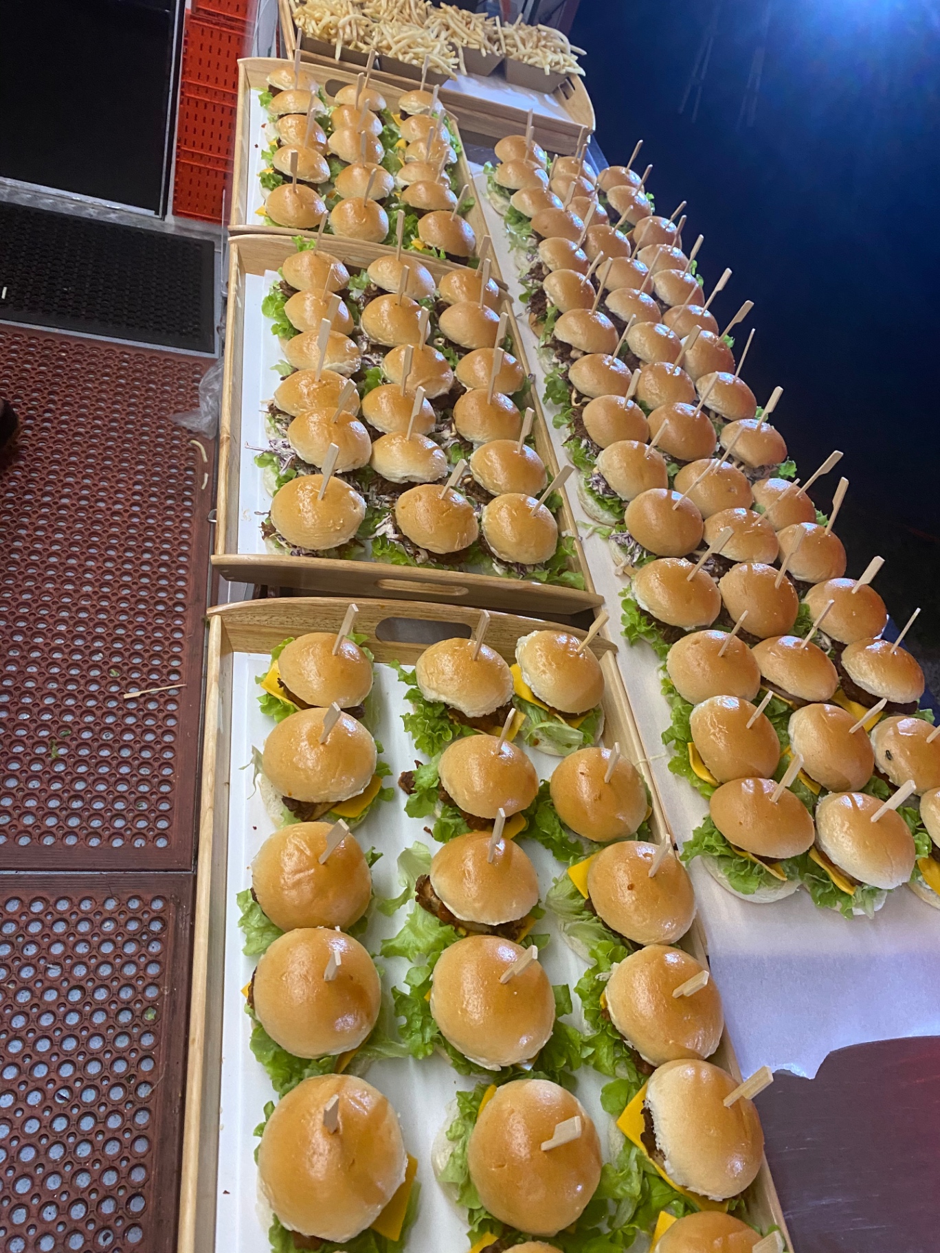 Boxes of beef sliders lined up for wedding catering service