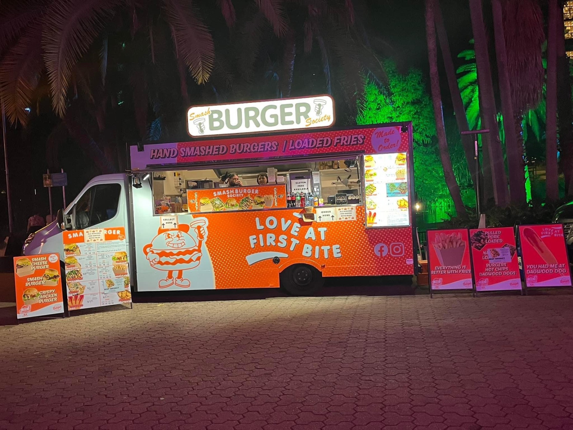 Smash Burger Society food truck lit up serving a night crowd at a Gold Coast event